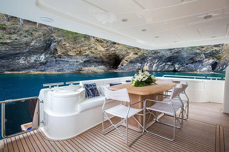 a table and chairs on a balcony aboard MONTICELLO II Yacht for Sale