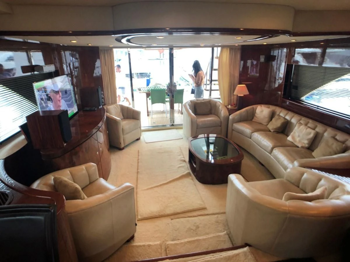 a living room with a large window aboard FAIRLINE SQUADRON 74 Yacht for Sale