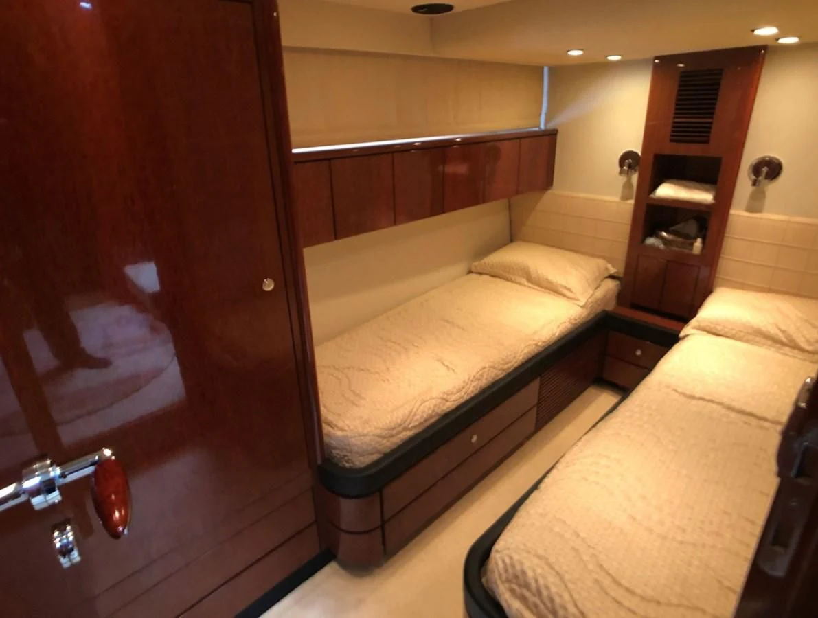 a room with a bed and a shelf aboard FAIRLINE SQUADRON 74 Yacht for Sale