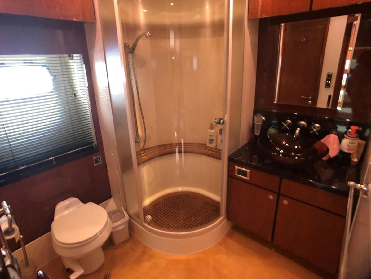 a bathroom with a shower and toilet aboard FAIRLINE SQUADRON 74 Yacht for Sale