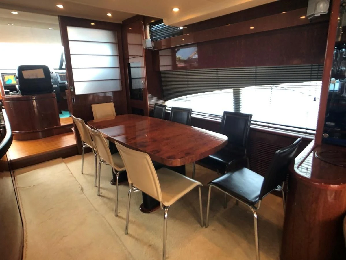 a room with a table and chairs aboard FAIRLINE SQUADRON 74 Yacht for Sale