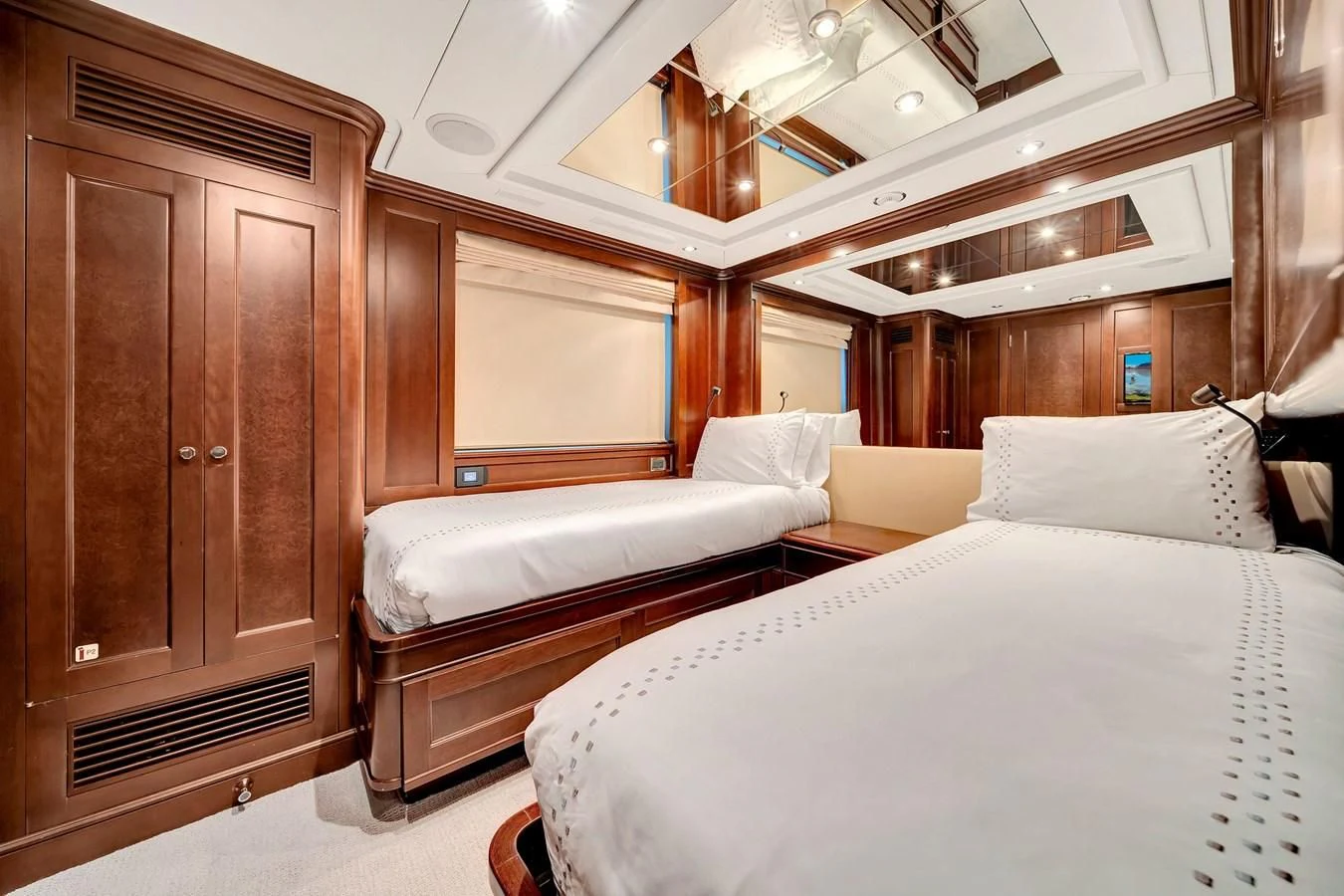 a room with a bed and a cupboard aboard CRISTOBAL Yacht for Charter