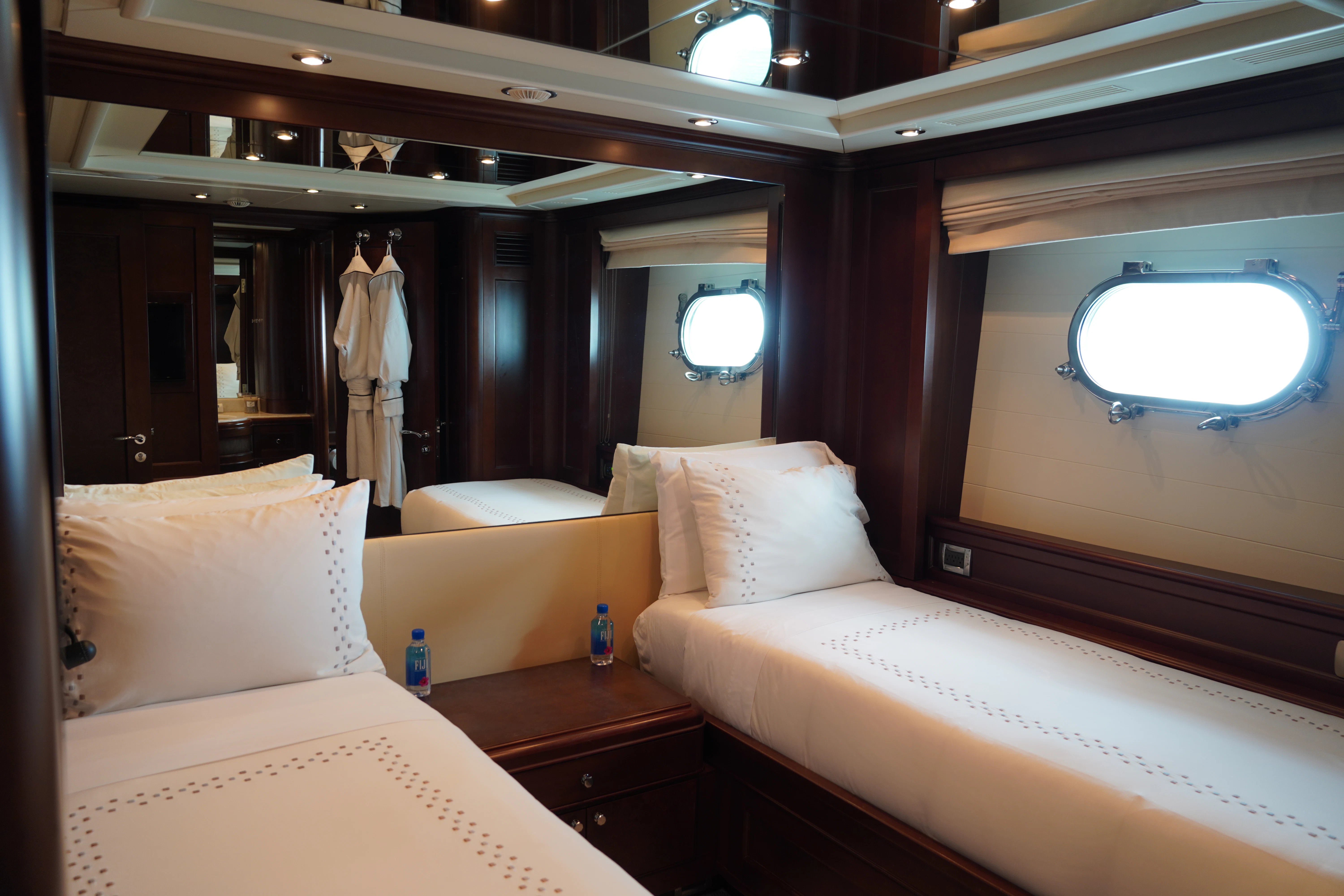 a room with beds and a window aboard CRISTOBAL Yacht for Charter