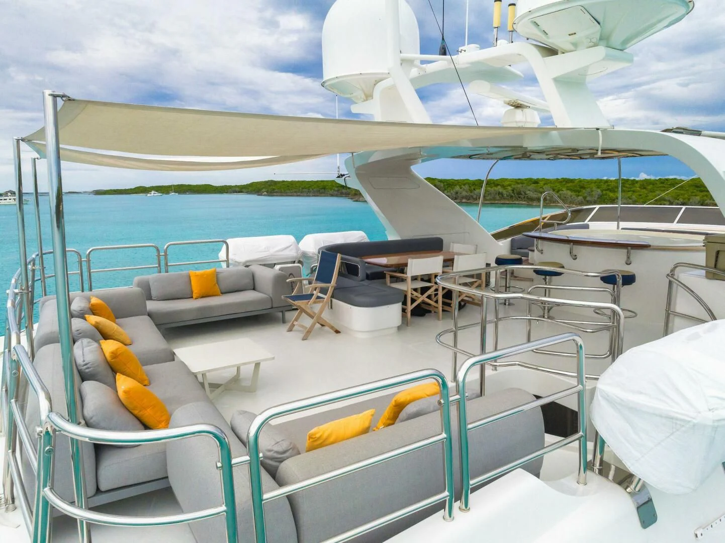 a pool with lounge chairs and umbrellas on a sunny day aboard CRISTOBAL Yacht for Charter
