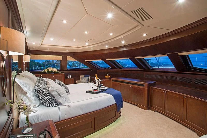 a room with a bed and a table aboard CRISTOBAL Yacht for Charter