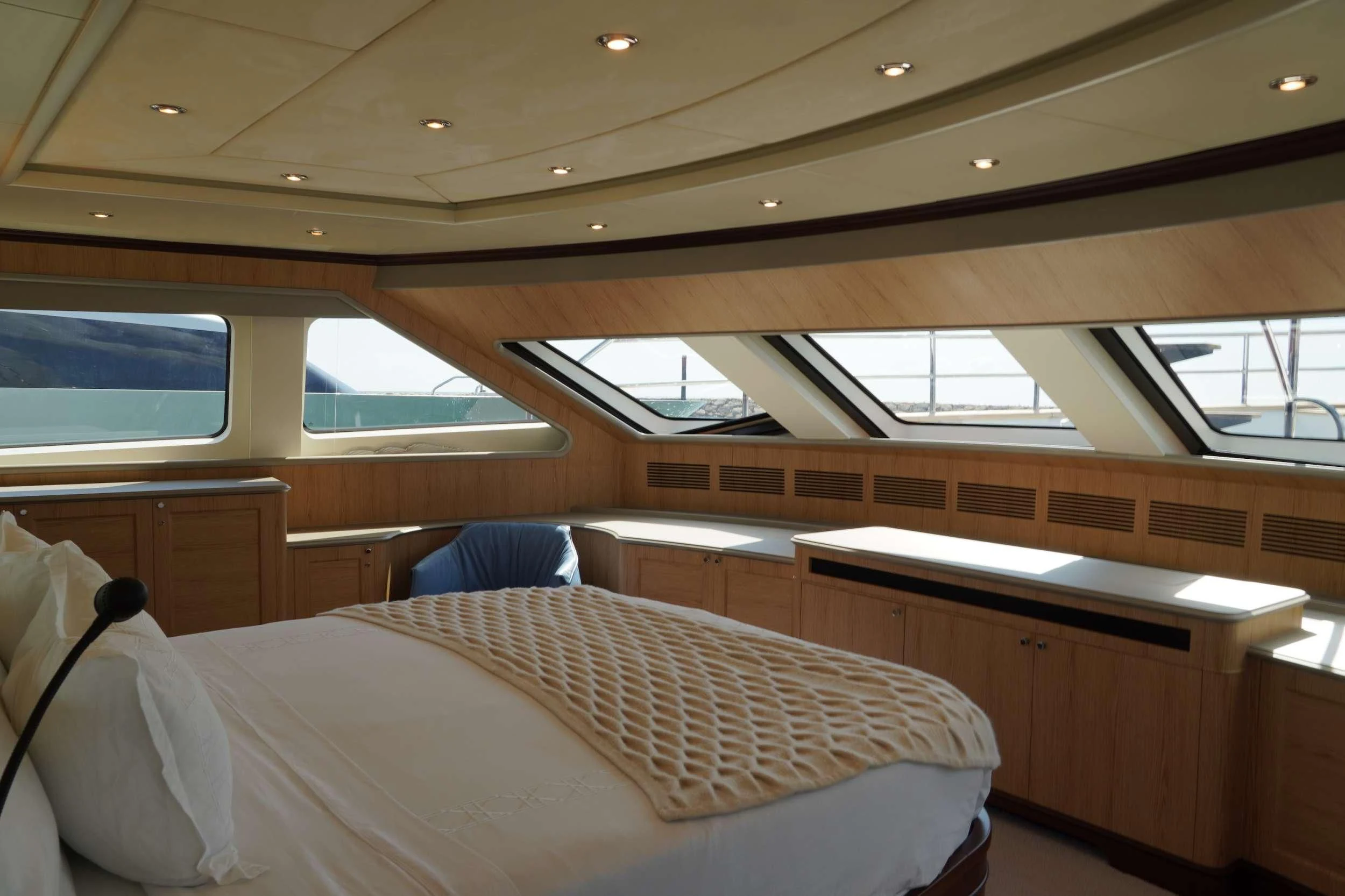 a room with a bed and a desk aboard CRISTOBAL Yacht for Charter
