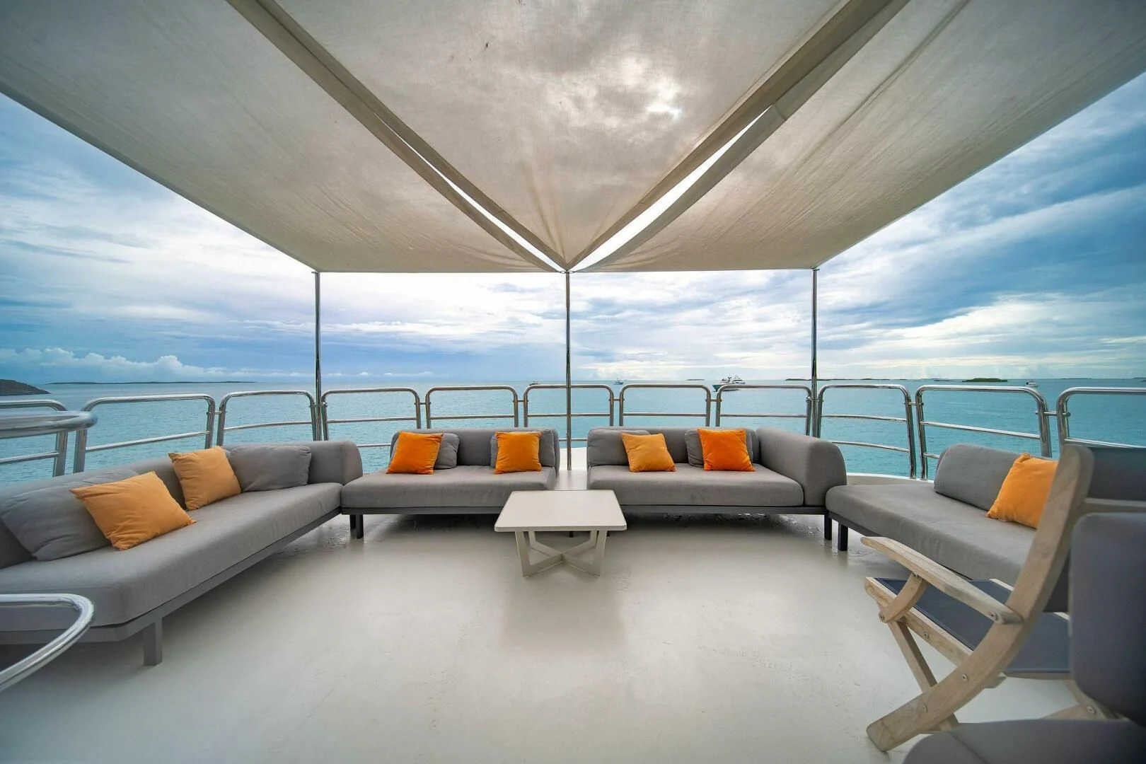 a room with a couch and a table and a large window aboard CRISTOBAL Yacht for Charter