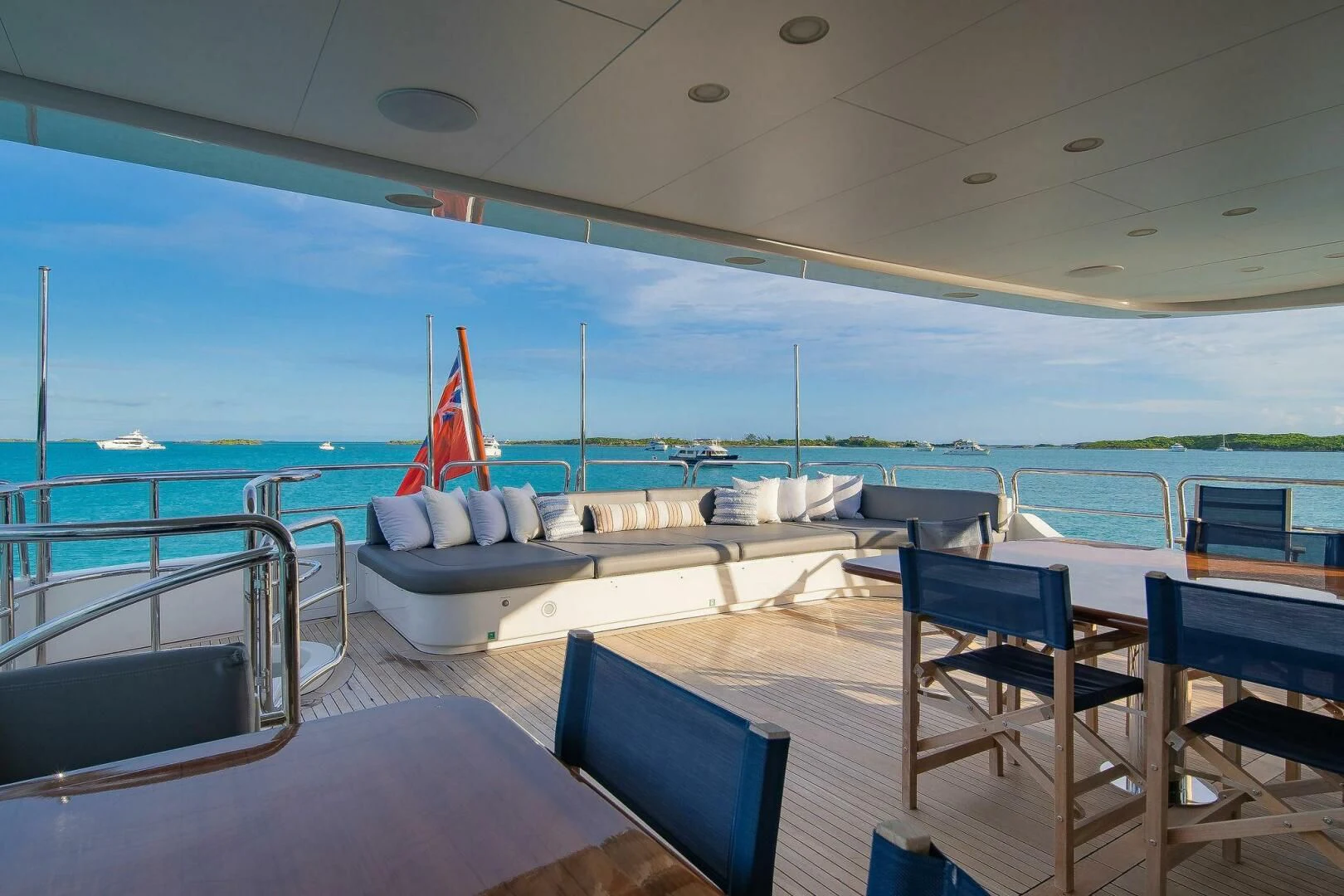 a large lounge area with a large pool and lounge chairs aboard CRISTOBAL Yacht for Charter