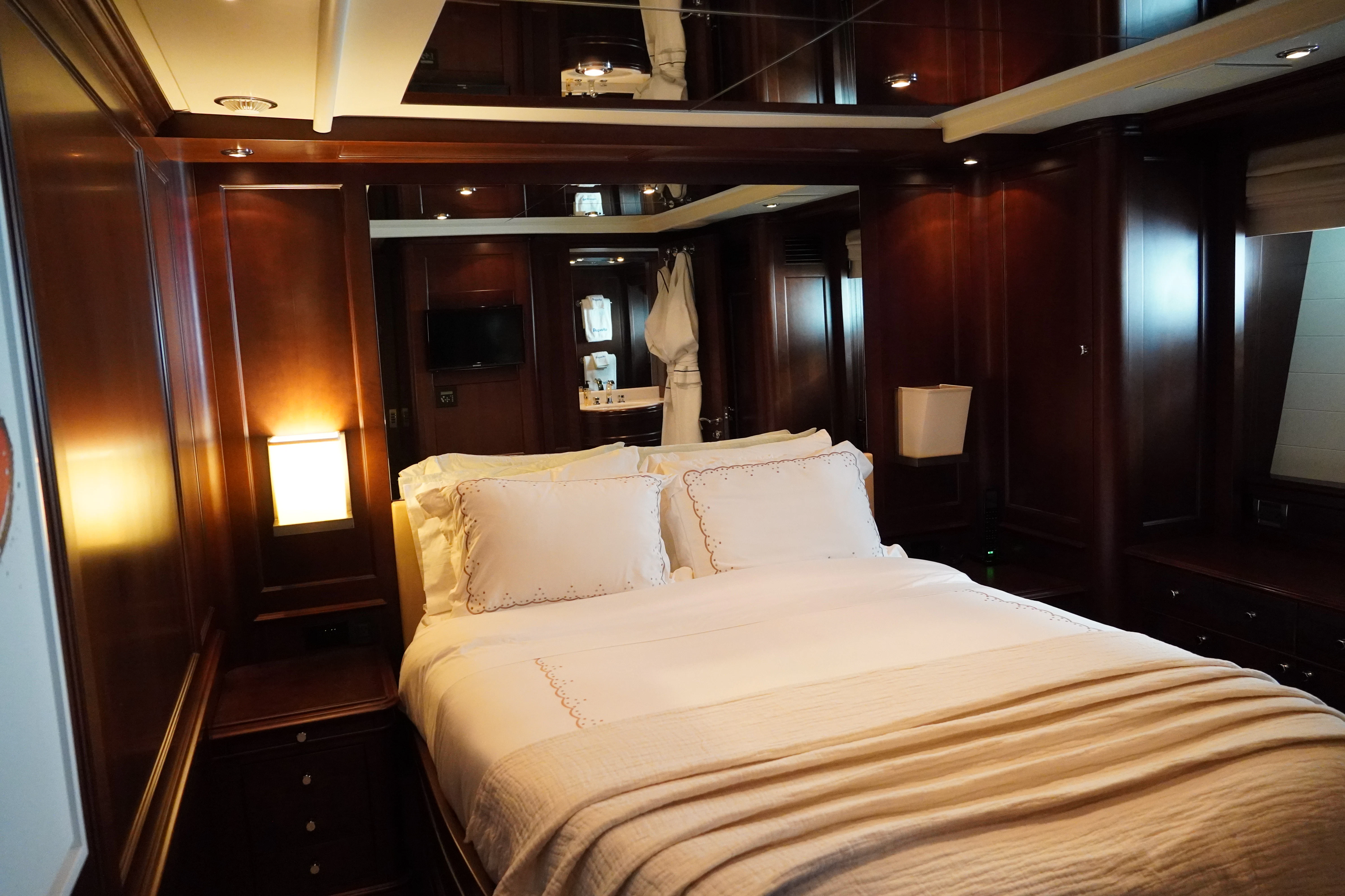 a bed with white sheets aboard CRISTOBAL Yacht for Charter
