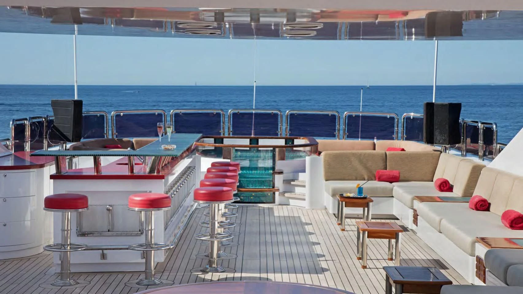 a room with chairs and tables aboard CODE 8 Yacht for Sale