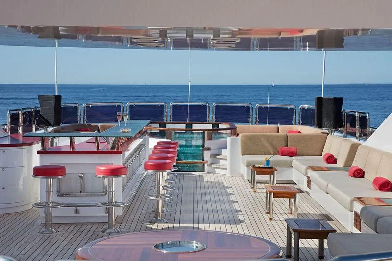a room with chairs and tables aboard CODE 8 Yacht for Sale