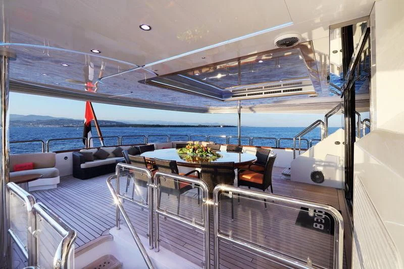 a boat with a table and chairs aboard CODE 8 Yacht for Sale