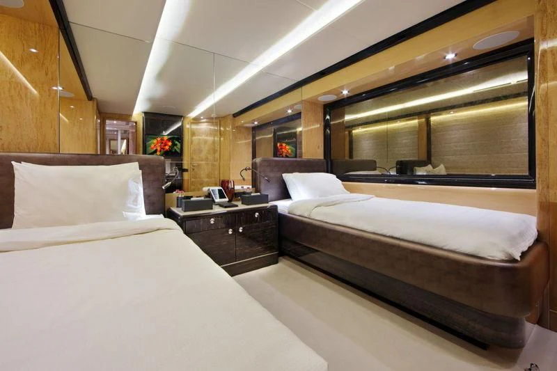 a room with two beds aboard CODE 8 Yacht for Sale