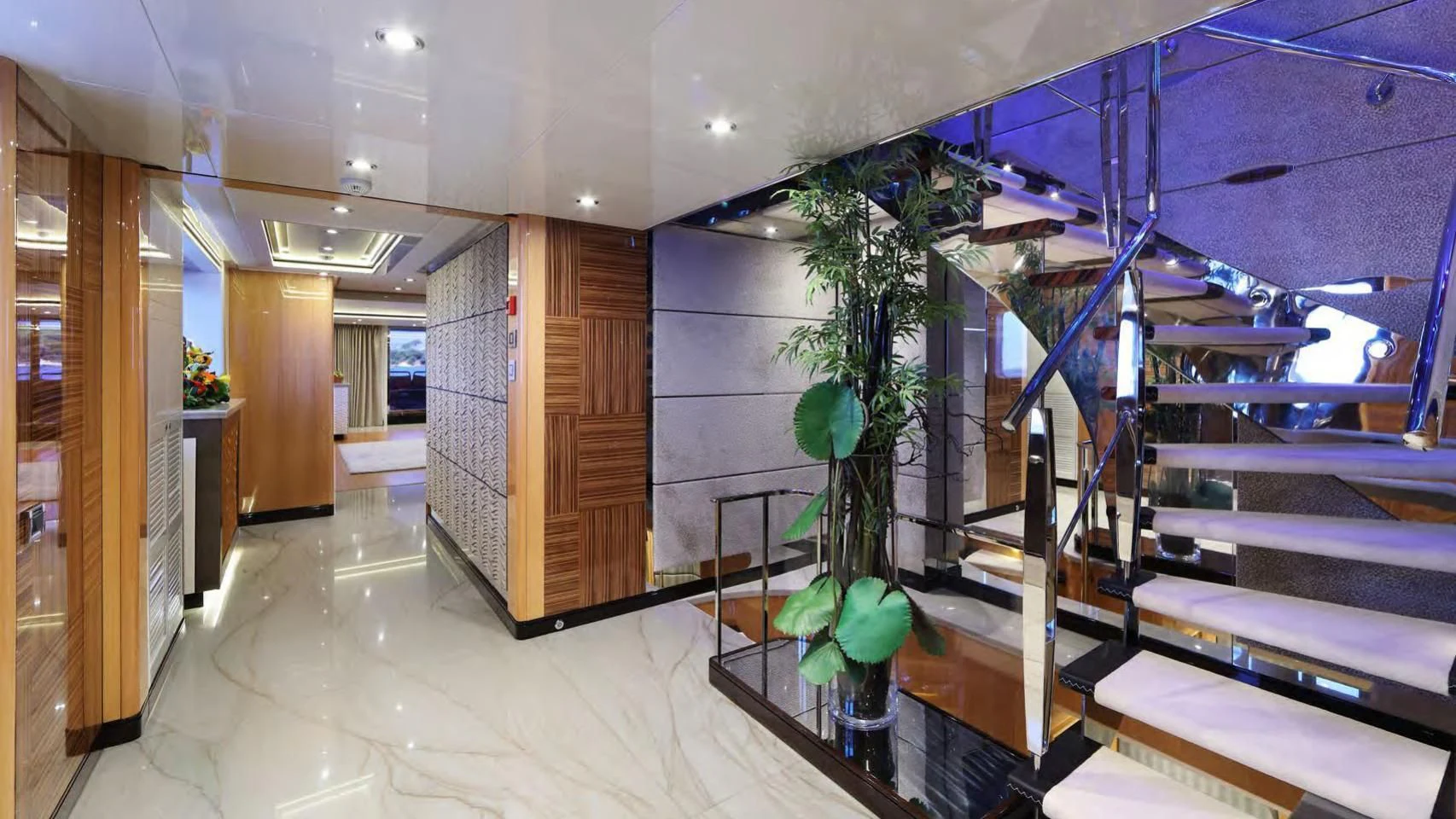 a room with a plant and a staircase aboard CODE 8 Yacht for Sale