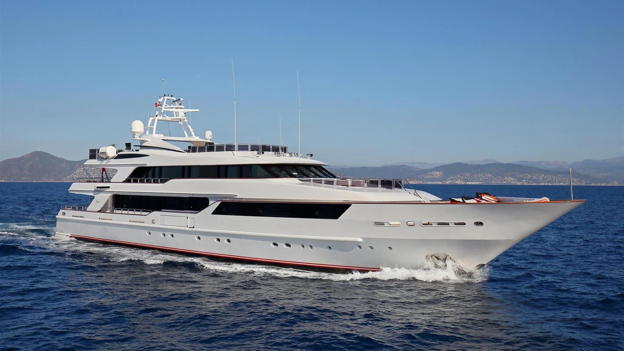 a white boat on the water aboard CODE 8 Yacht for Sale