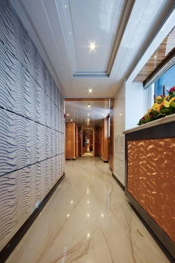 a hallway with a tile wall and windows aboard CODE 8 Yacht for Sale