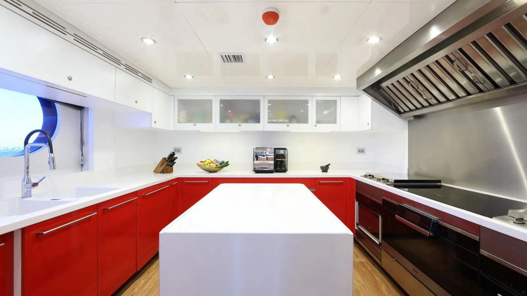 a kitchen with red cabinets aboard CODE 8 Yacht for Sale