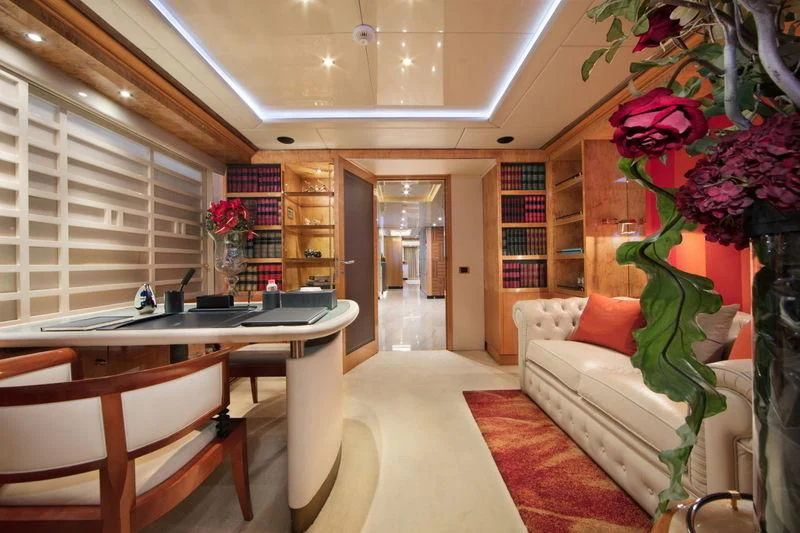 a living room with a couch and a table aboard CODE 8 Yacht for Sale