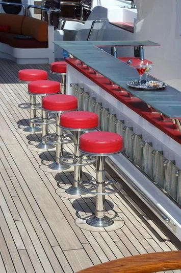 a group of stools in a room aboard CODE 8 Yacht for Sale