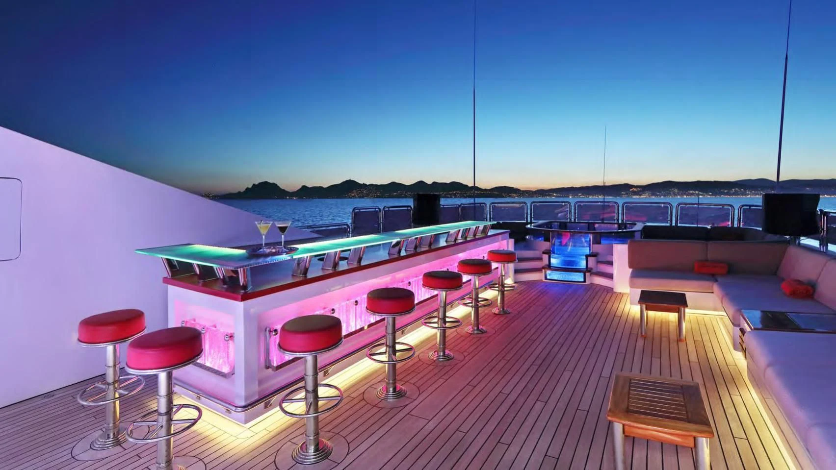 a room with a pool table and stools aboard CODE 8 Yacht for Sale