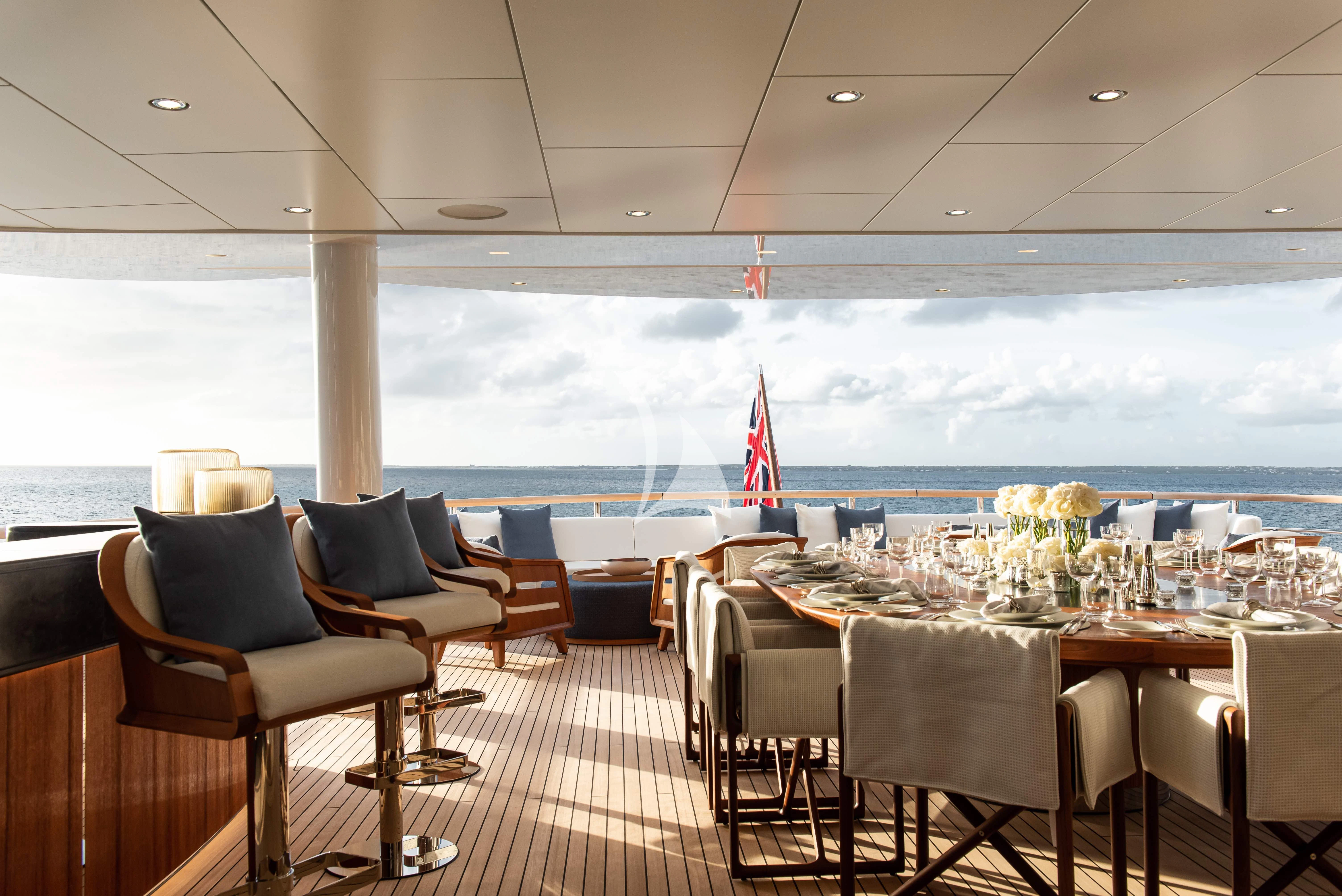 a room with tables and chairs aboard SYNTHESIS Yacht for Sale