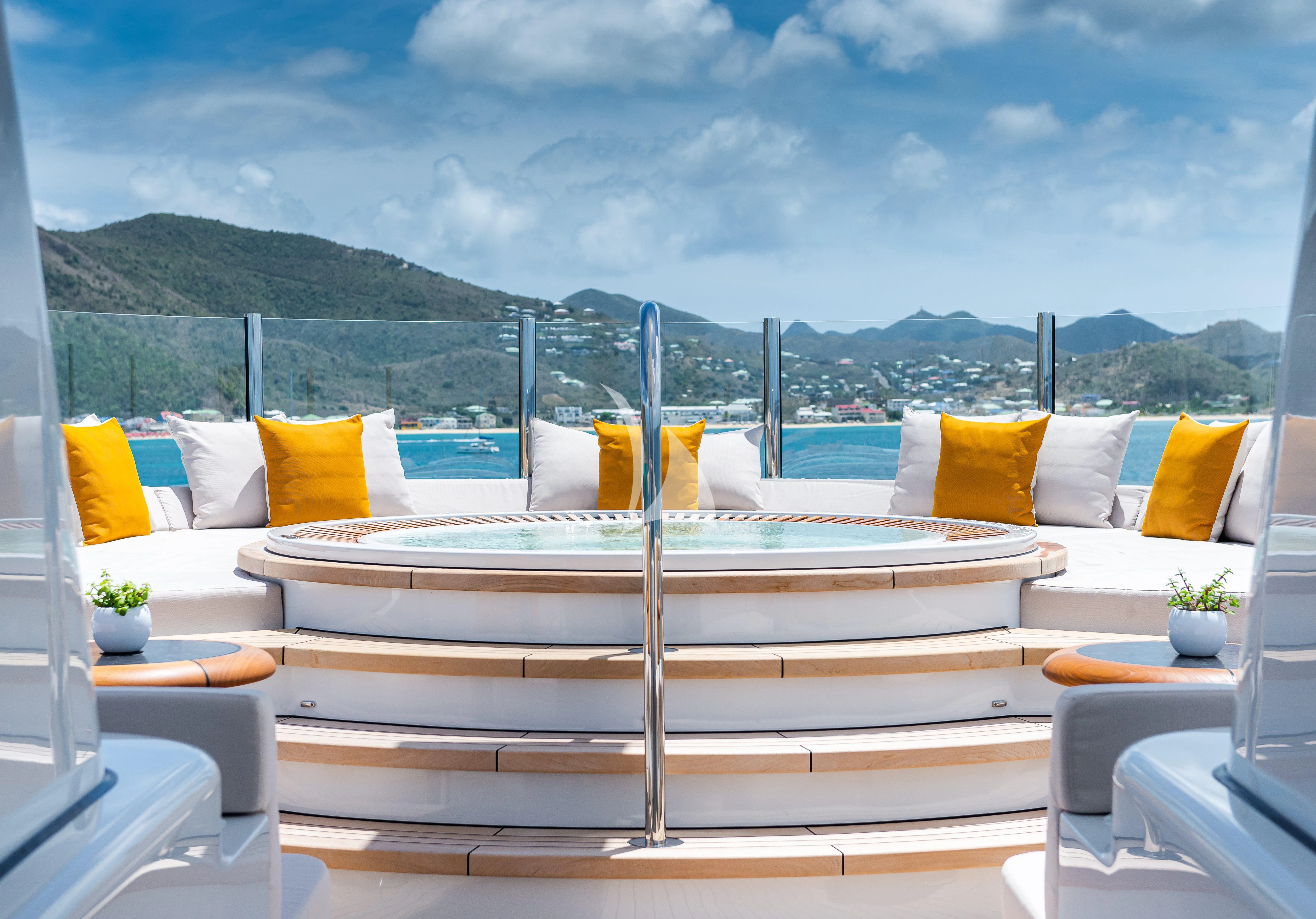 a room with a bed and pillows aboard SYNTHESIS Yacht for Sale