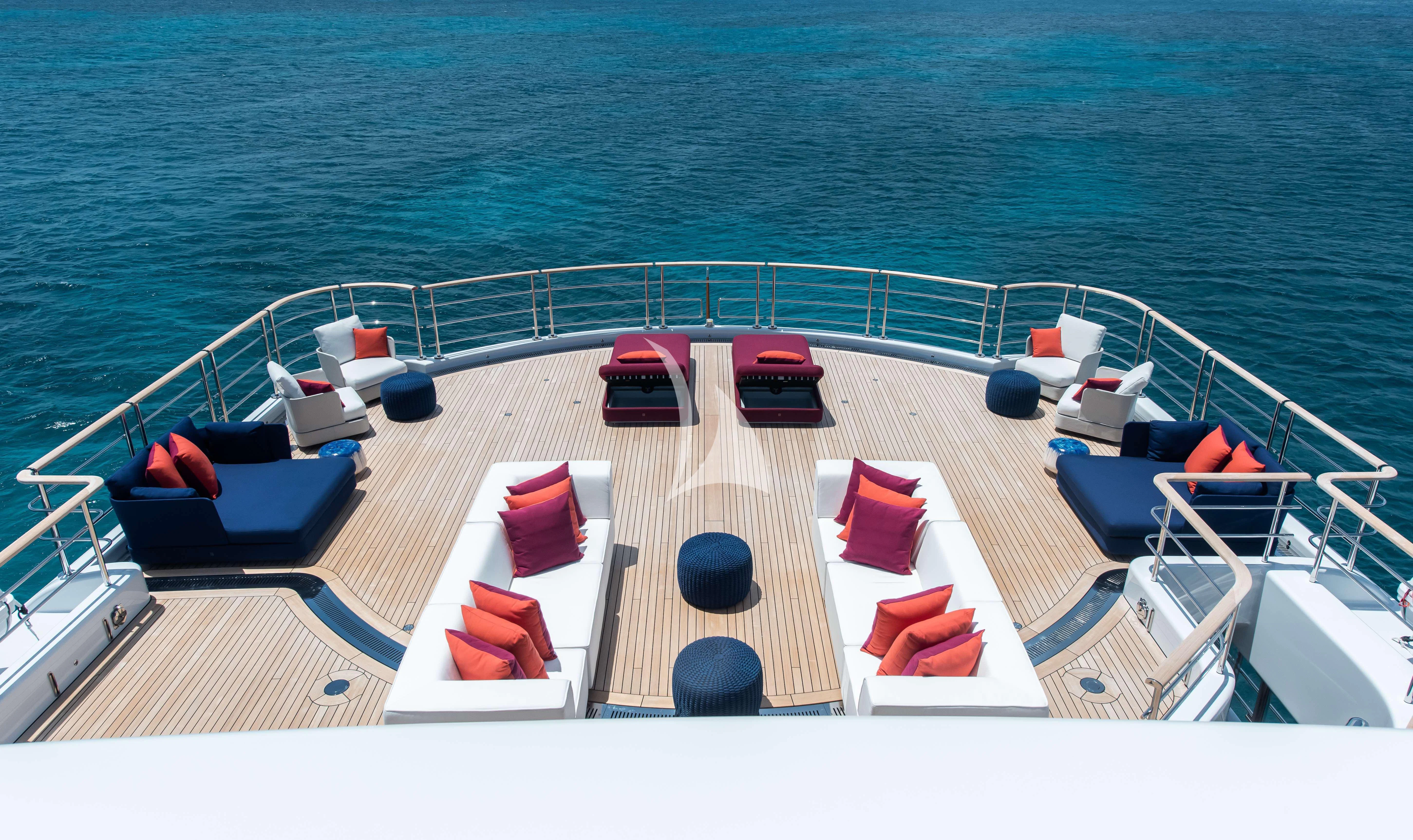 a large white boat with red seats on a deck by the water aboard SYNTHESIS Yacht for Sale