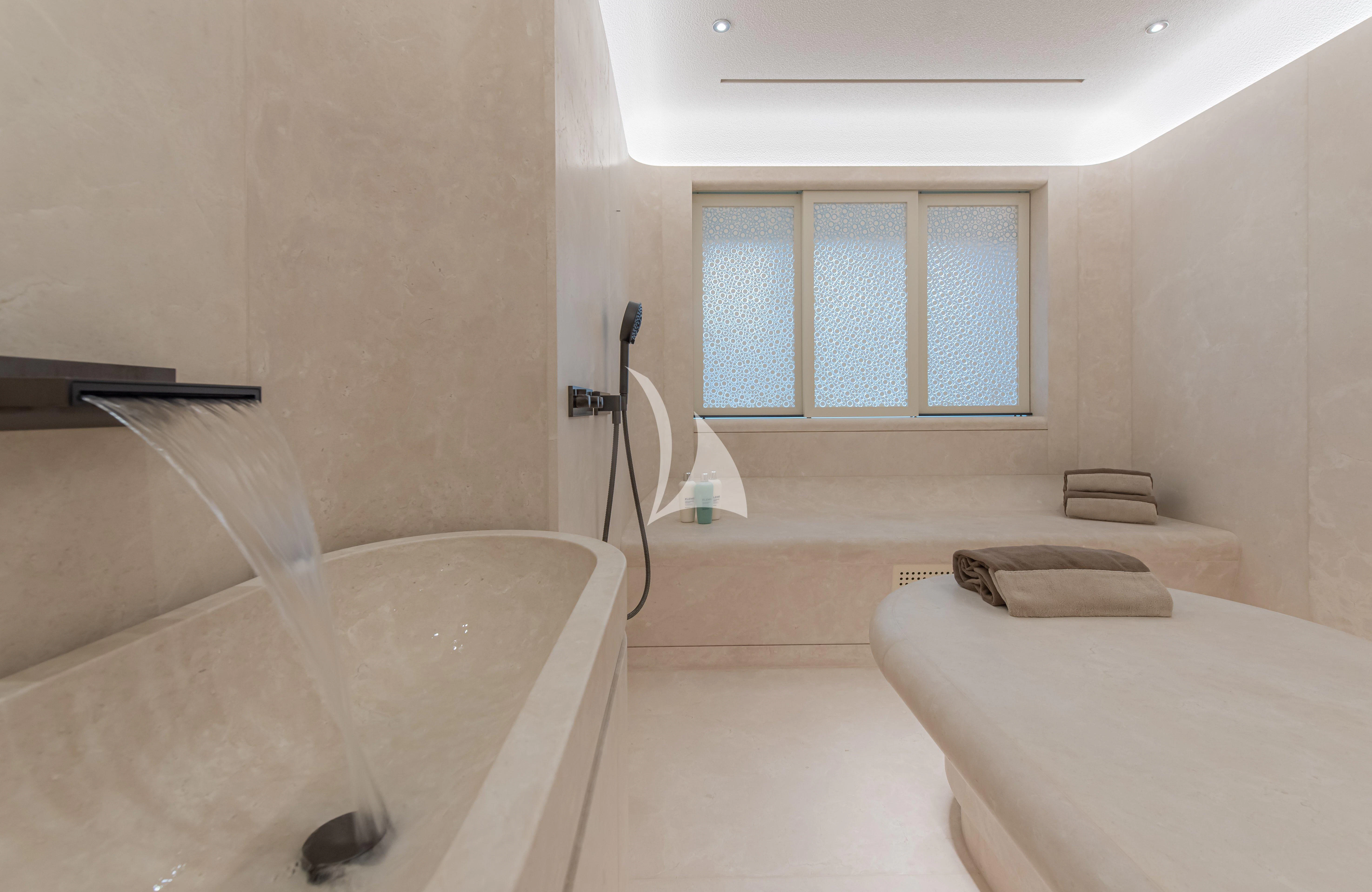 a bathroom with a tub and a sink aboard SYNTHESIS Yacht for Sale