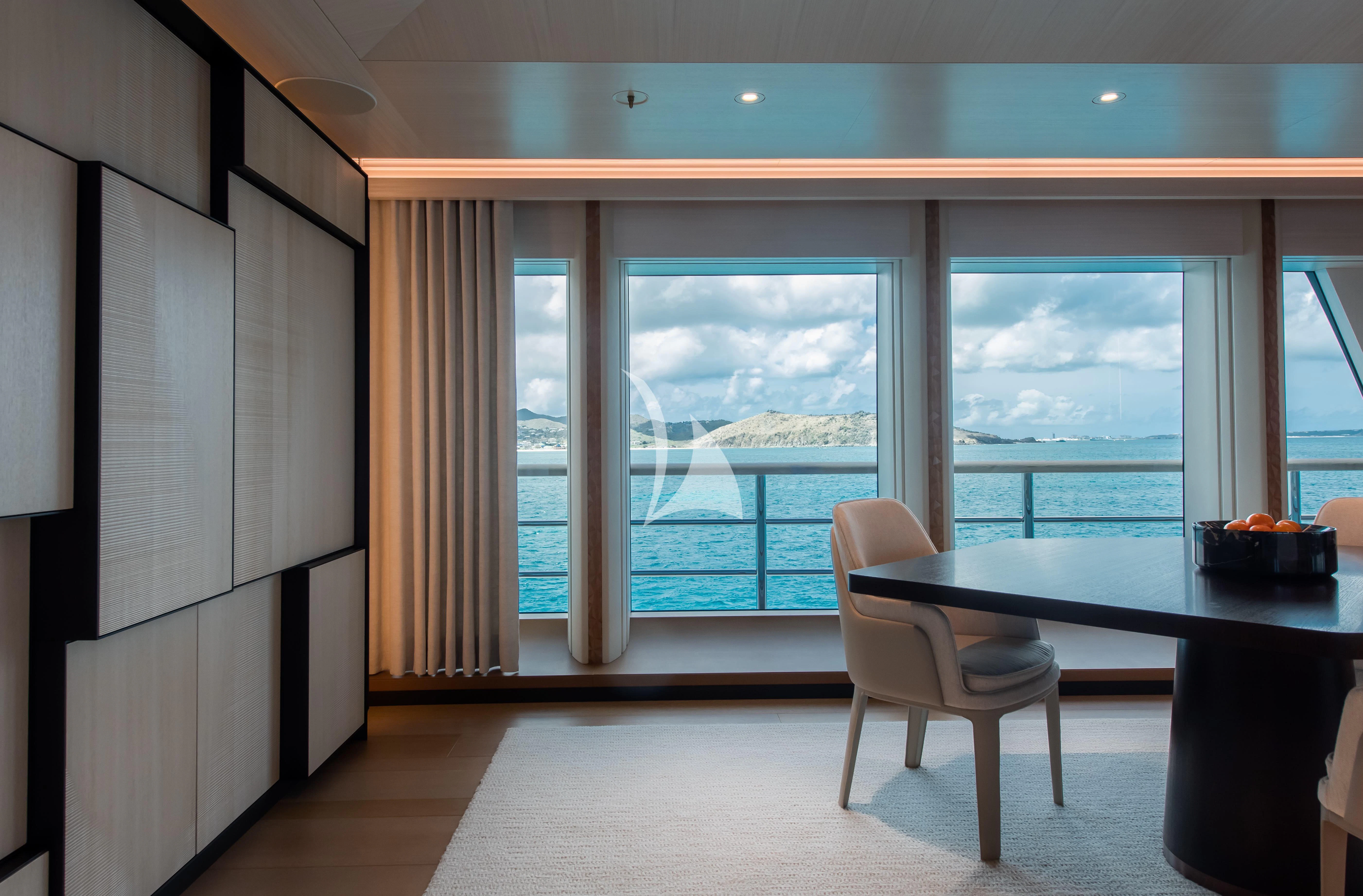 a room with a table and chairs aboard SYNTHESIS Yacht for Sale