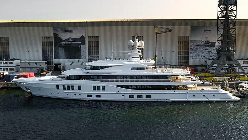 a white yacht in a harbor aboard SYNTHESIS Yacht for Sale