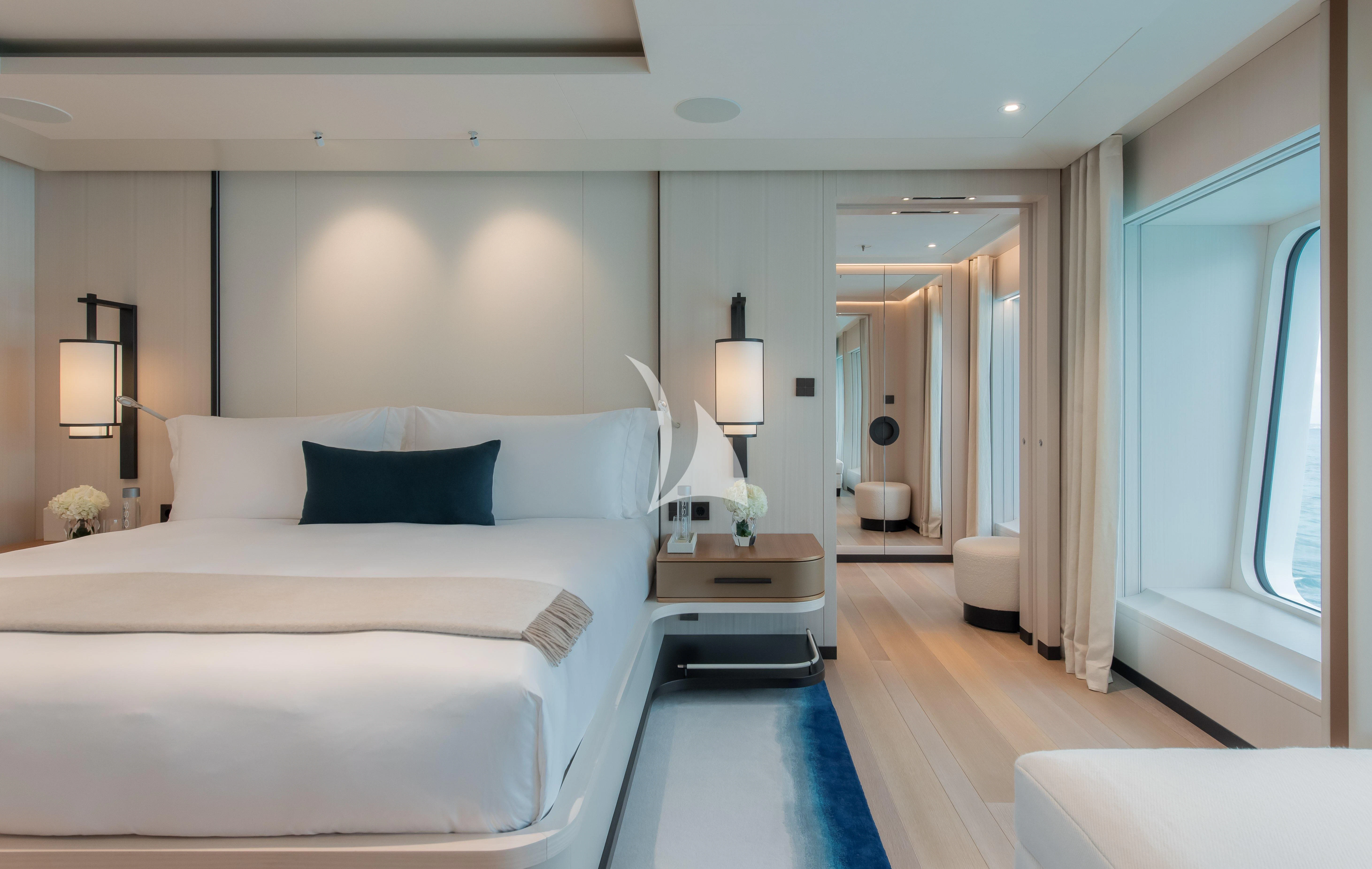 a bedroom with a bed and a mirror aboard SYNTHESIS Yacht for Sale