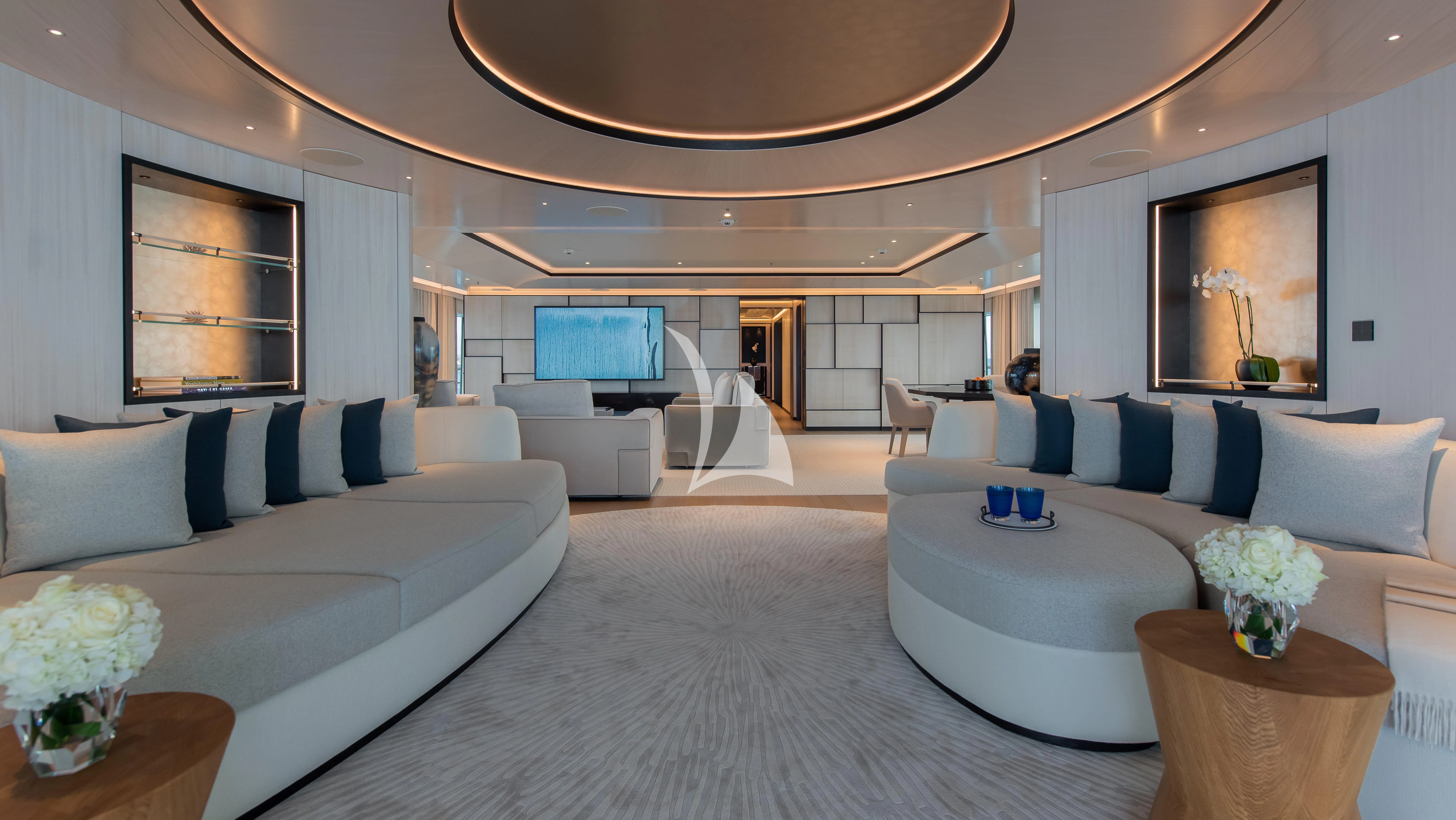 a living room with a large chandelier aboard SYNTHESIS Yacht for Sale