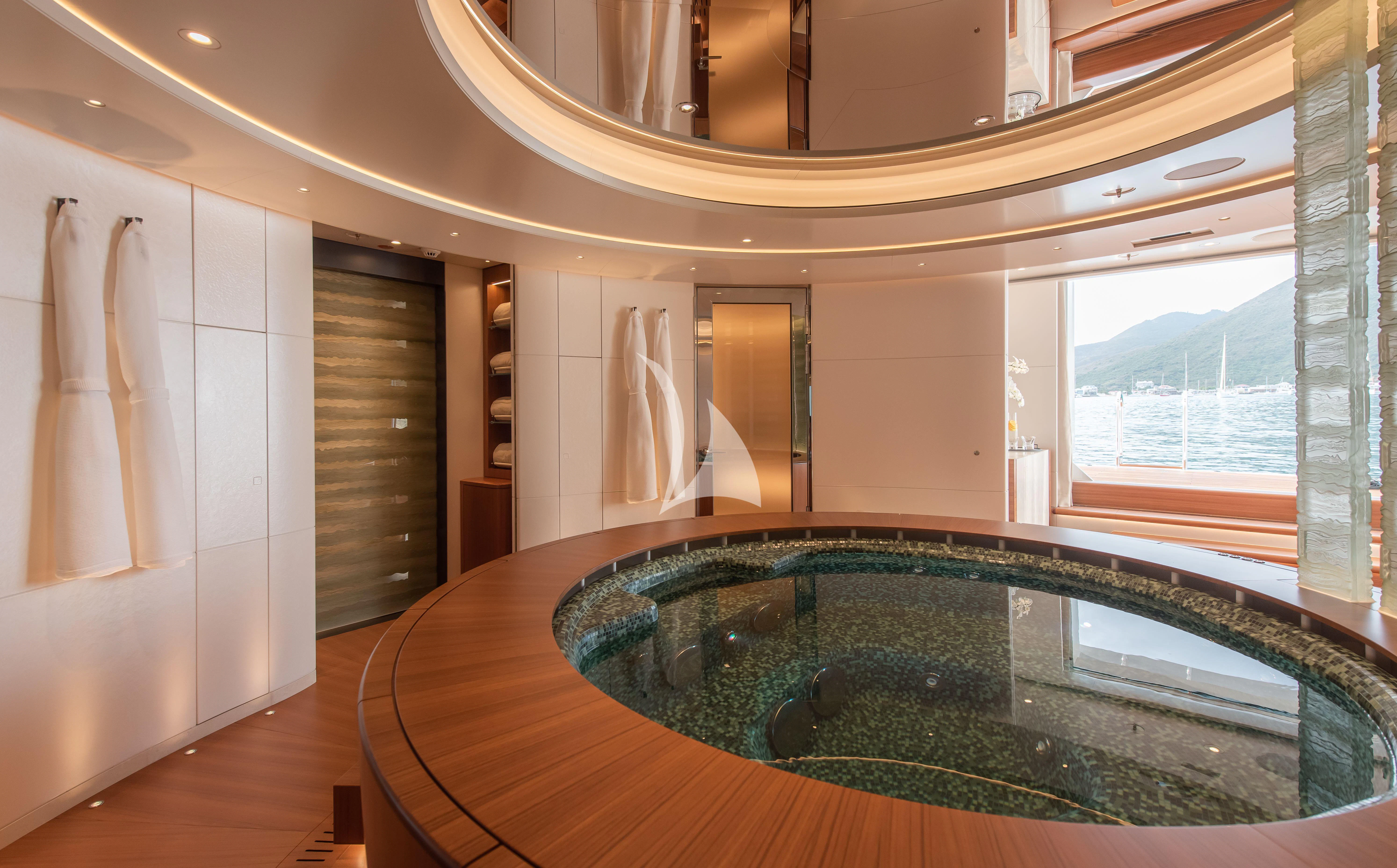 a large bathroom with a large jacuzzi aboard SYNTHESIS Yacht for Sale