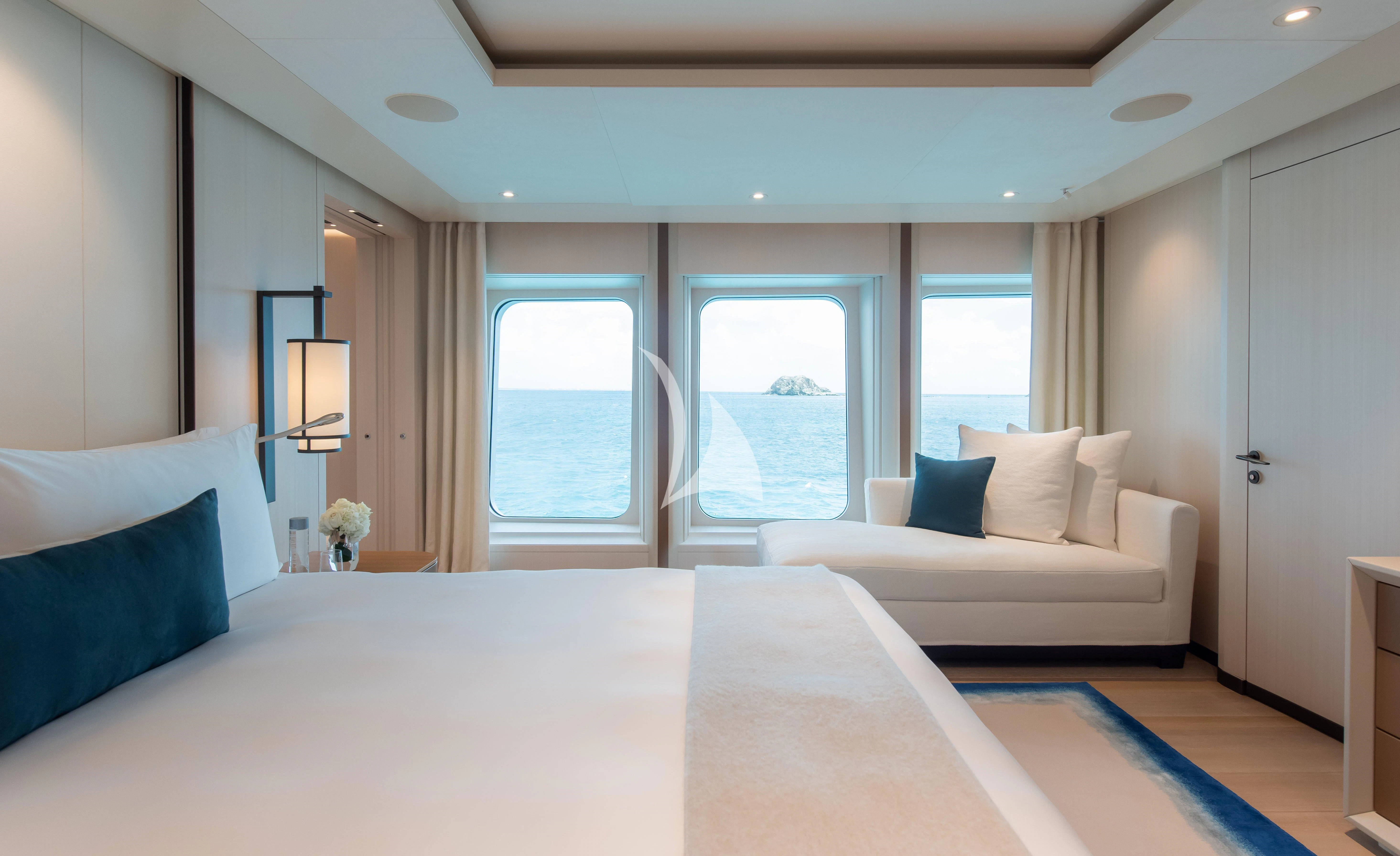 a room with a bed and a window aboard SYNTHESIS Yacht for Sale
