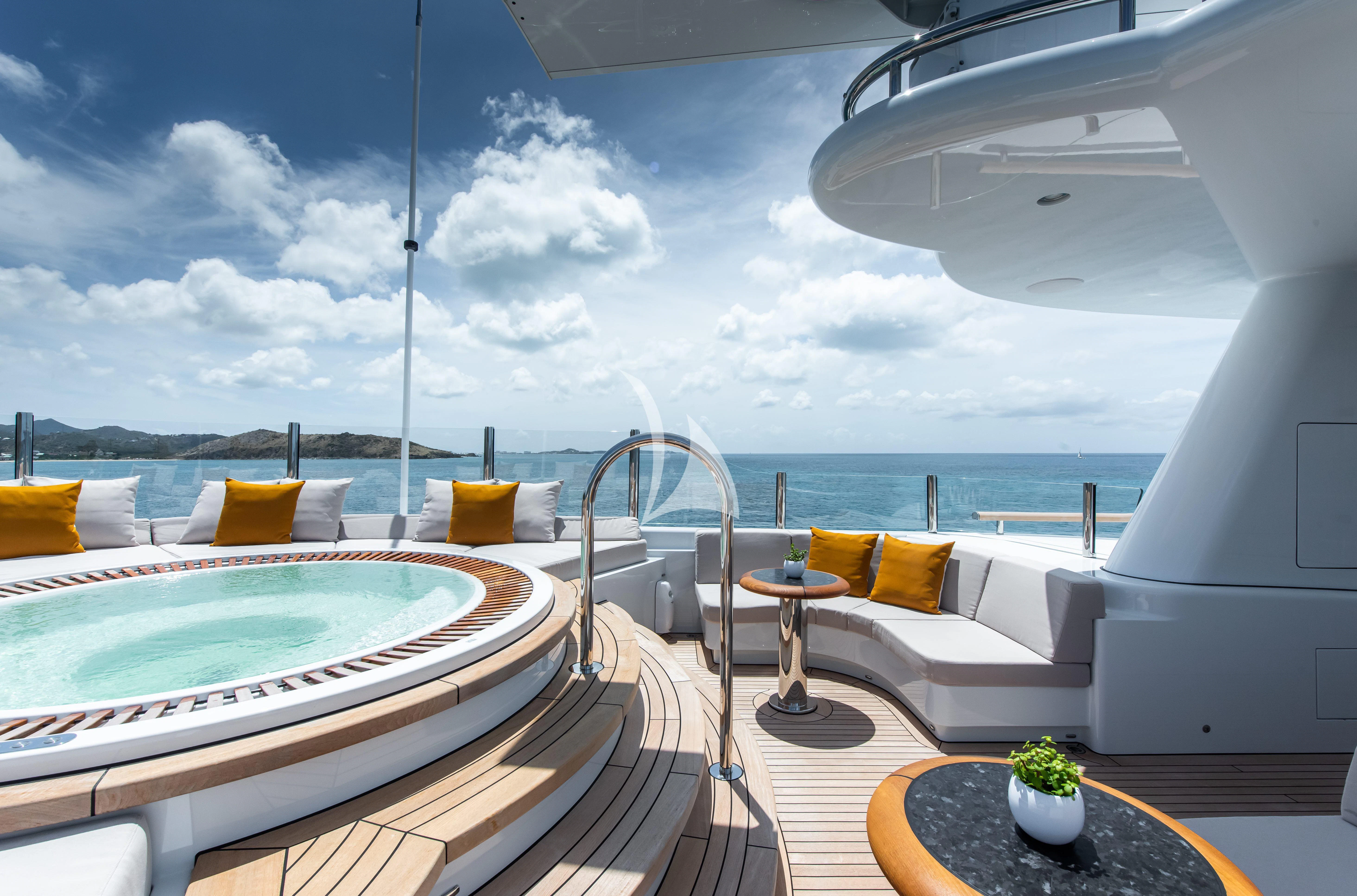 a room with a pool and a couch aboard SYNTHESIS Yacht for Sale
