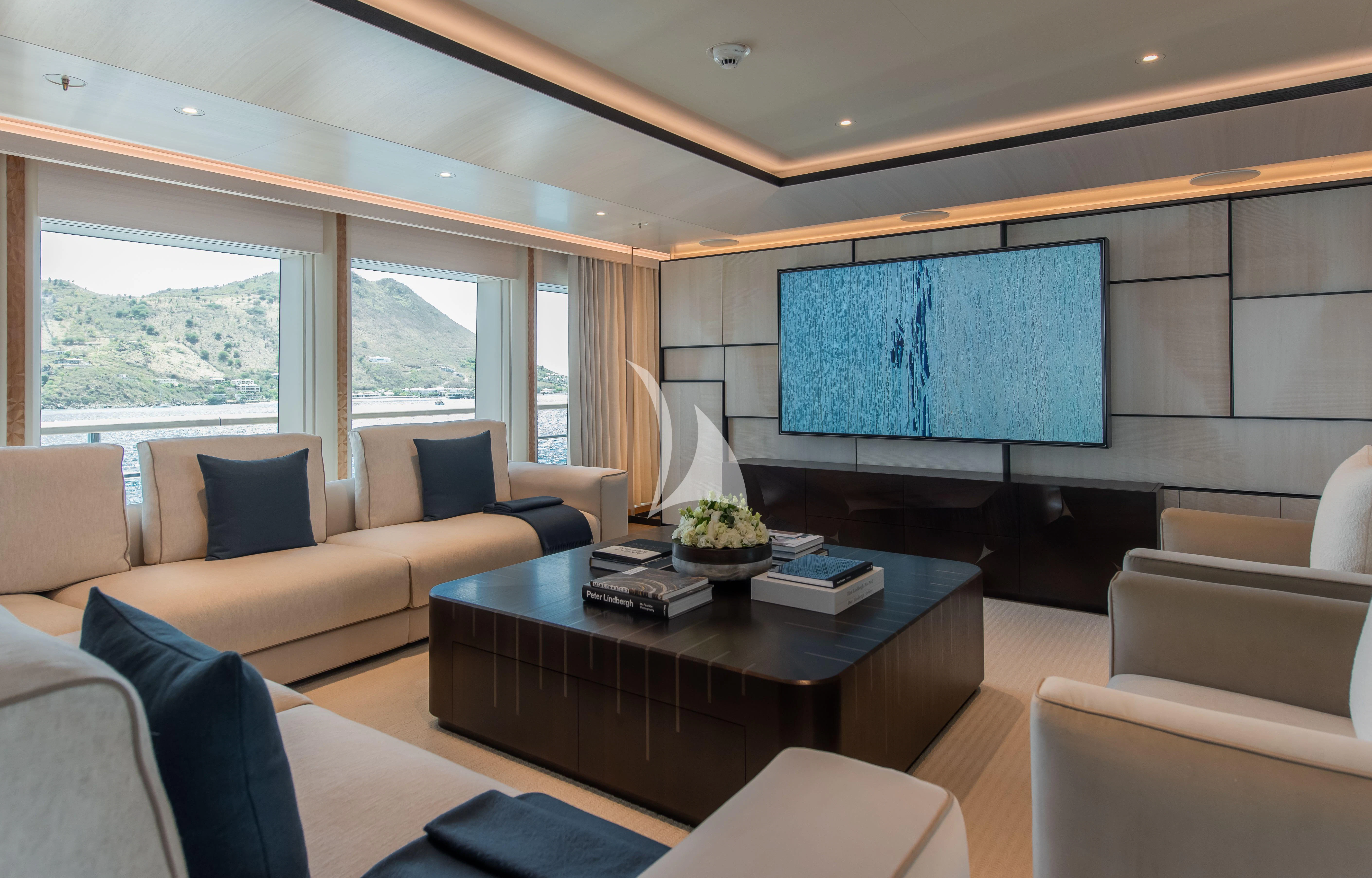 a living room with a large screen aboard SYNTHESIS Yacht for Sale