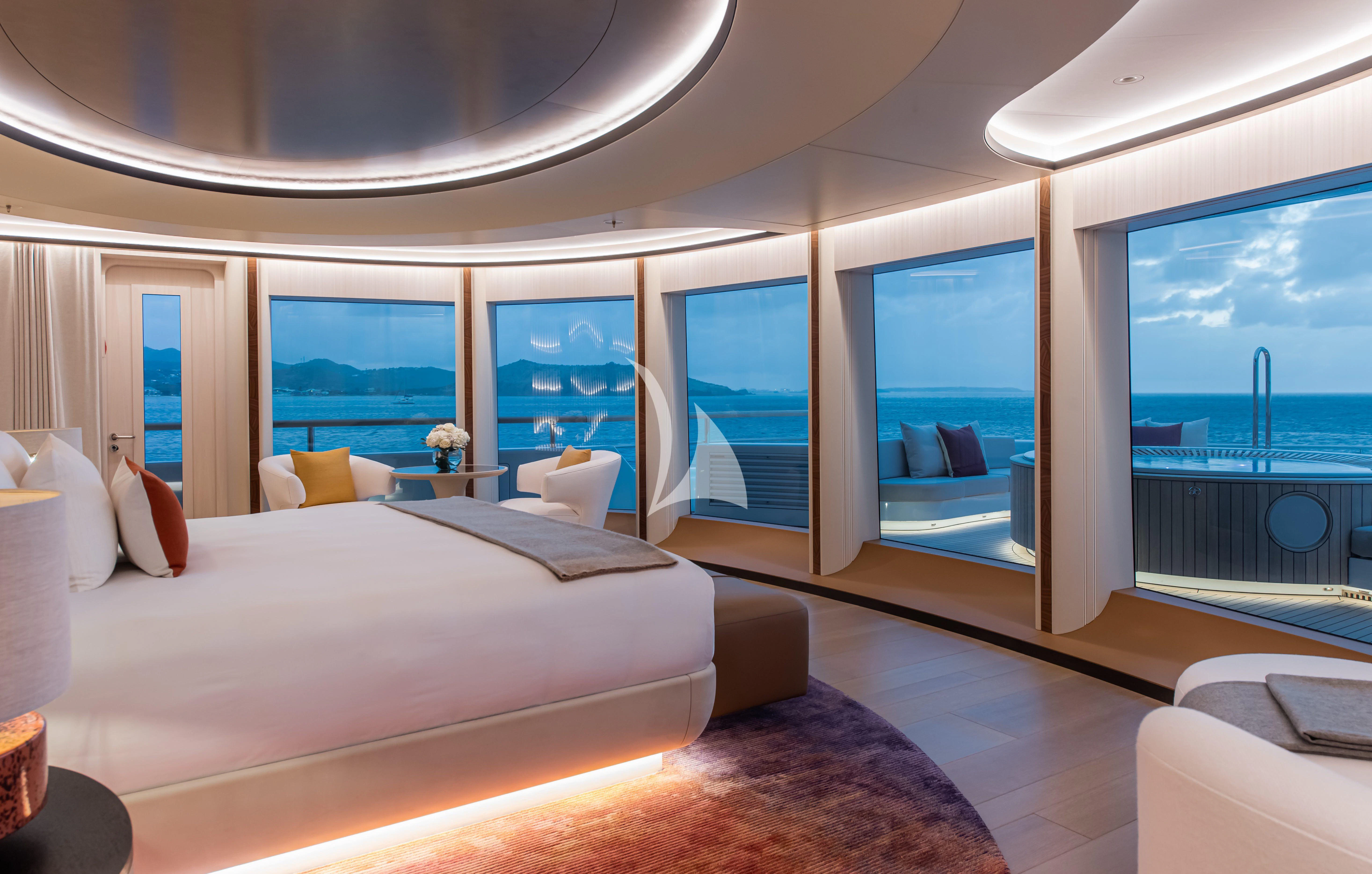 a room with a large bed and a large window aboard SYNTHESIS Yacht for Sale