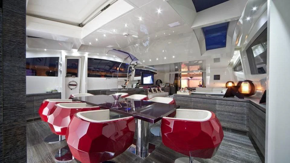 a room with tables and chairs aboard TOBY Yacht for Sale