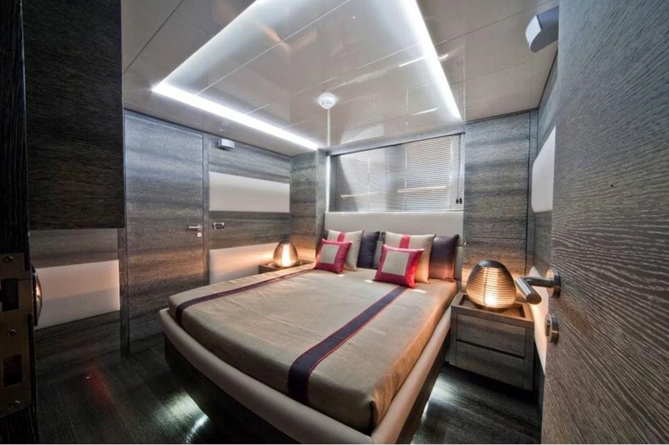 a room with a bed and a mirror aboard TOBY Yacht for Sale