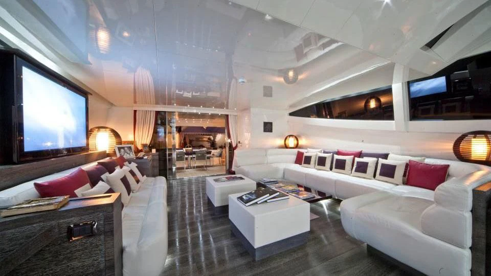 a living room with a large screen aboard TOBY Yacht for Sale