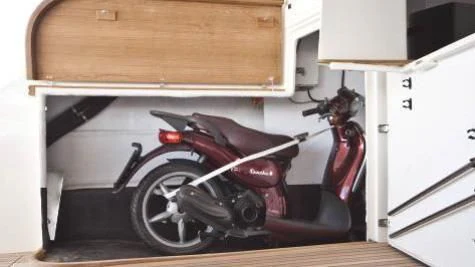 a motorcycle parked inside a garage aboard TOBY Yacht for Sale