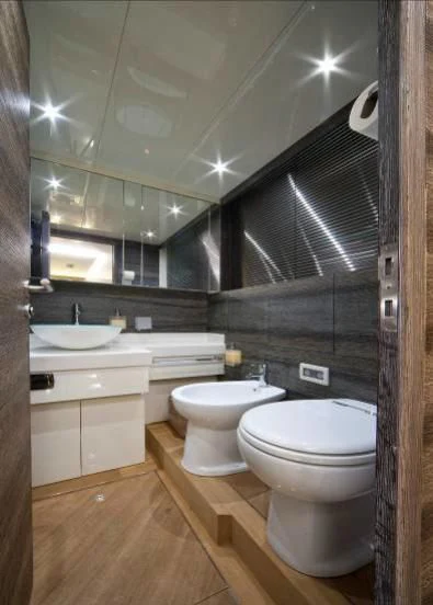 a bathroom with a large mirror aboard TOBY Yacht for Sale