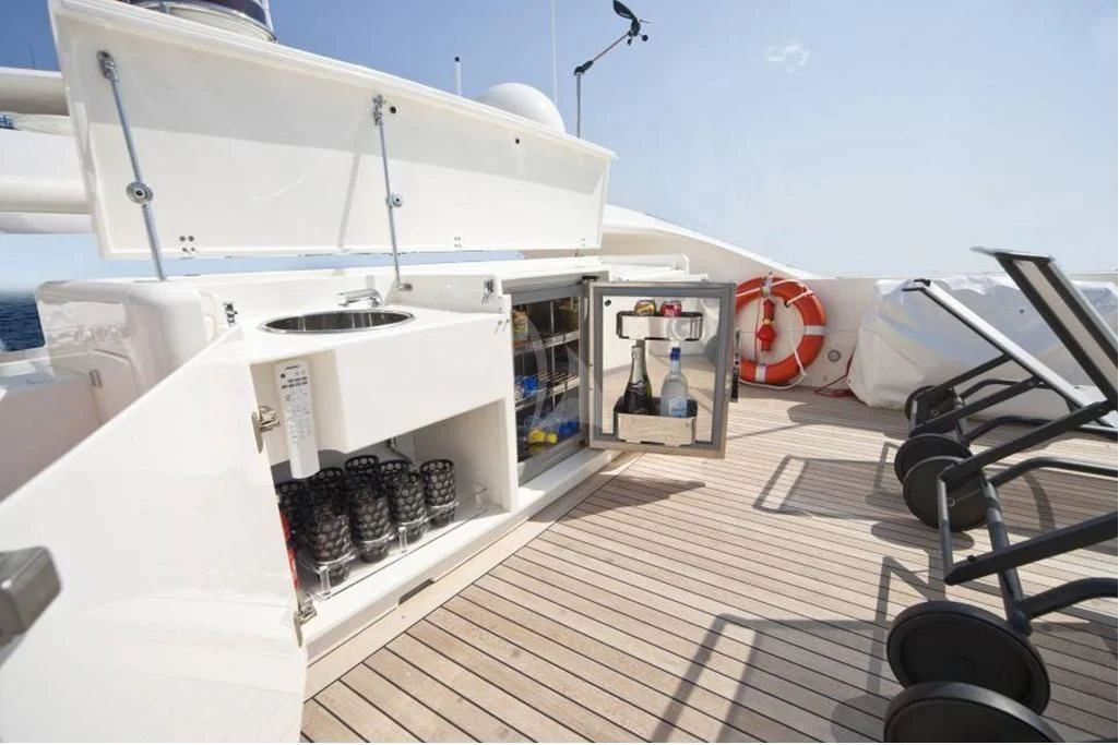 a white boat with a black and red stripe on the deck aboard TOBY Yacht for Sale