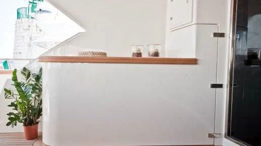 a white refrigerator with a few glasses on top aboard TOBY Yacht for Sale