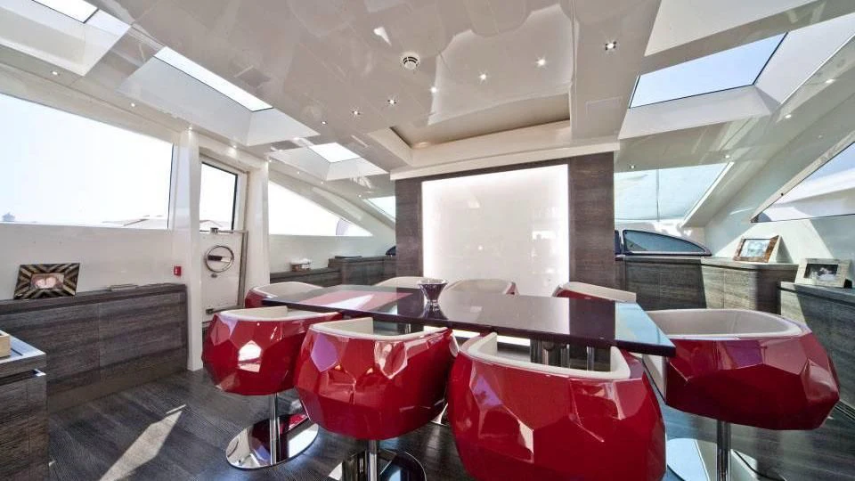 a room with tables and chairs aboard TOBY Yacht for Sale