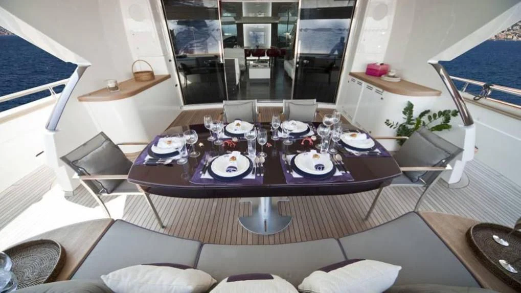 a dining table with plates and chairs aboard TOBY Yacht for Sale