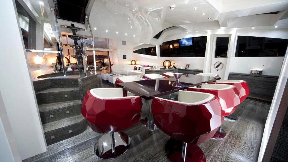 a room with a table and chairs aboard TOBY Yacht for Sale