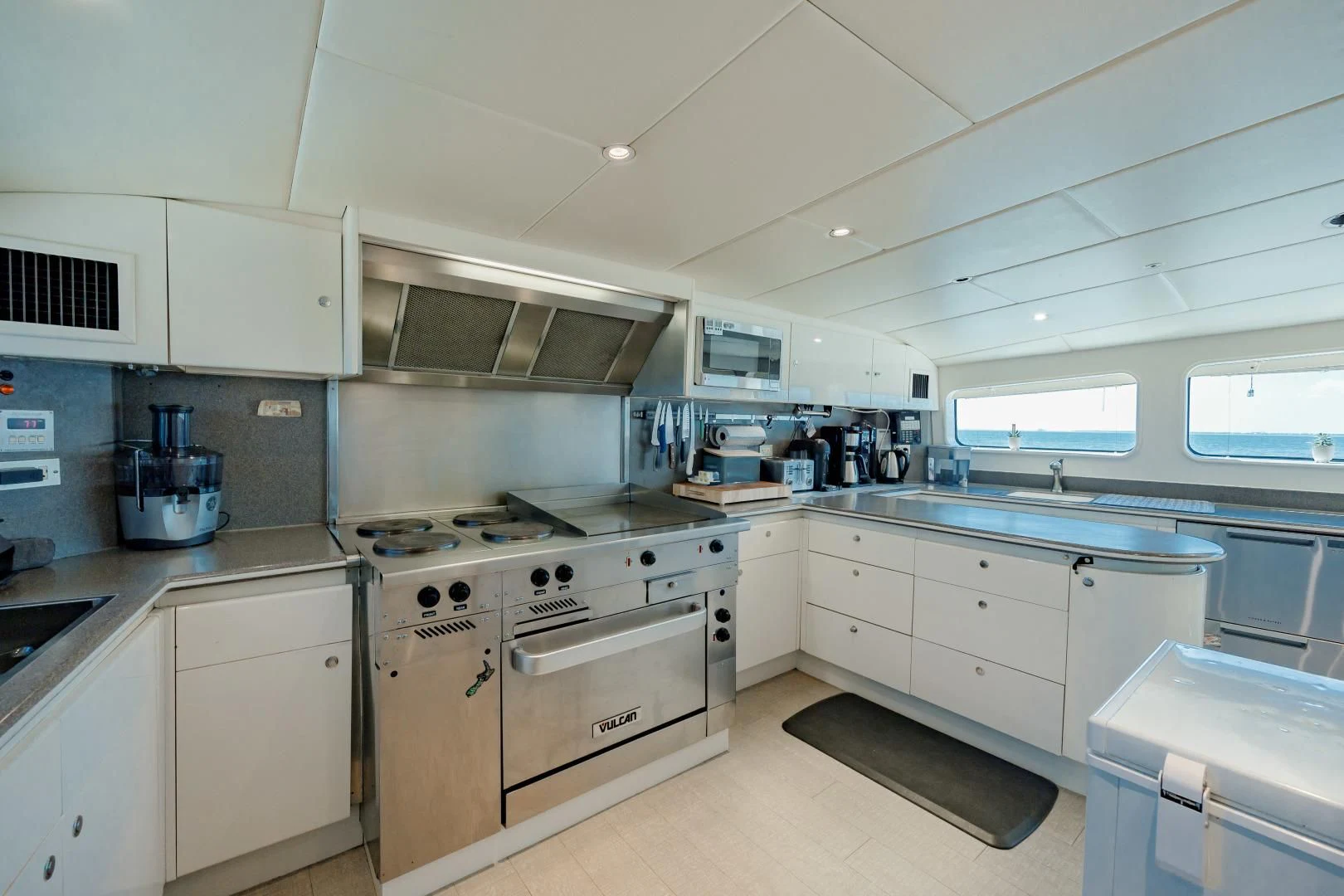 a kitchen with white cabinets aboard DREAM RIDER Yacht for Sale