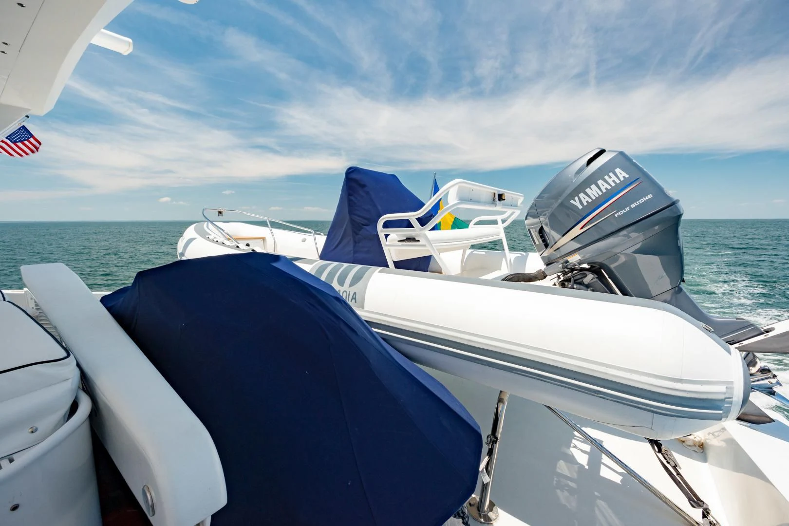 a boat with a flag on the back aboard DREAM RIDER Yacht for Sale