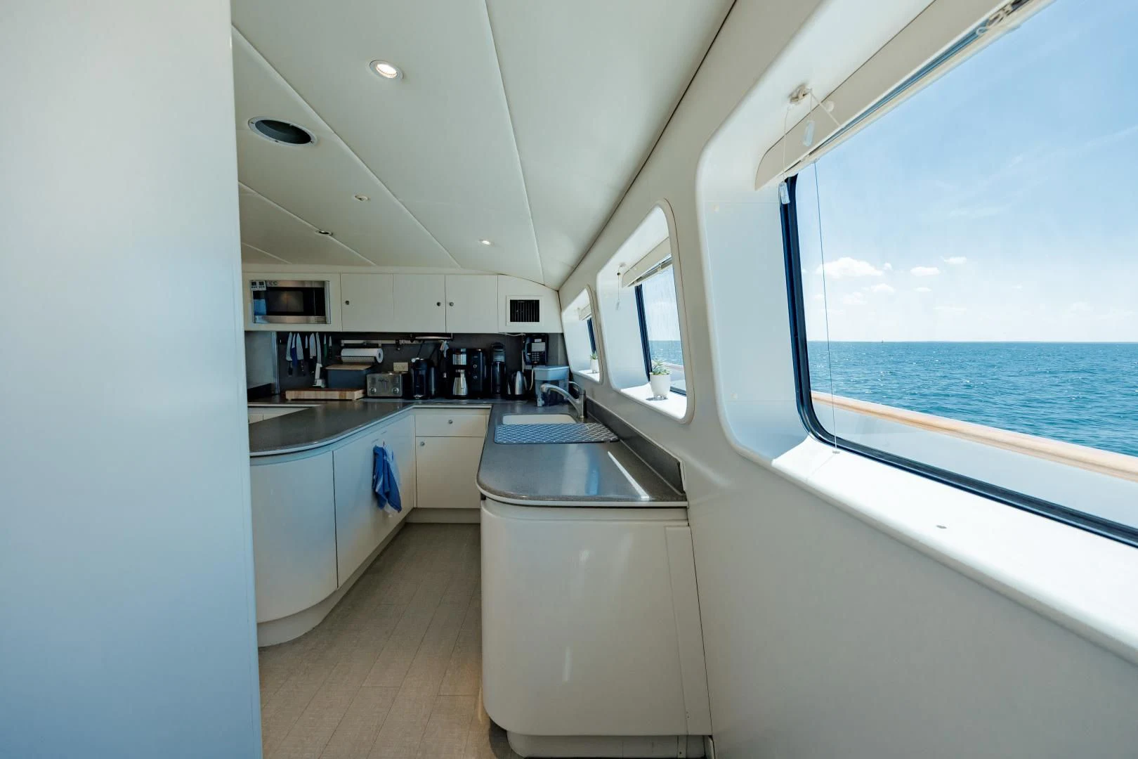 a kitchen with a large window aboard DREAM RIDER Yacht for Sale